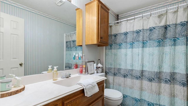 bathroom featuring curtained shower, wallpapered walls, toilet, and vanity