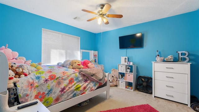 bedroom featuring visible vents, ceiling fan, and carpet