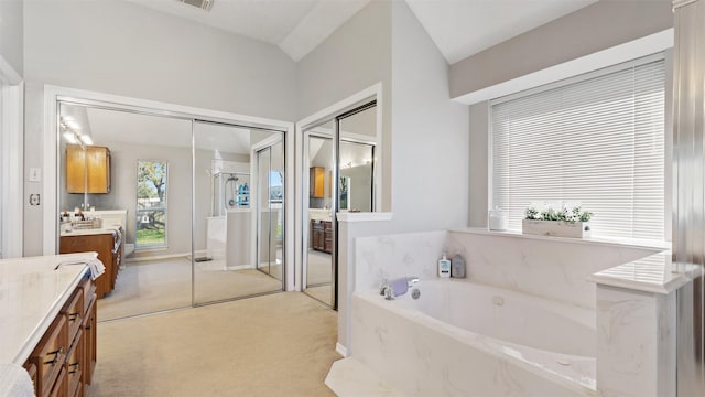 full bathroom with a shower with shower door, visible vents, a garden tub, and vanity