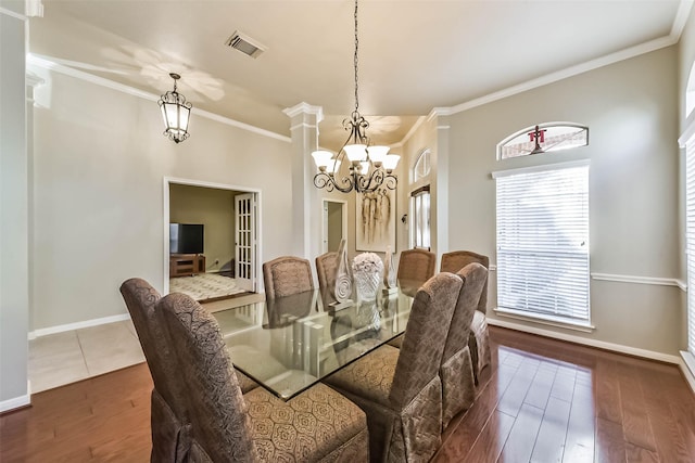 dining room featuring crown molding, wood finished floors, and visible vents