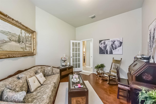 living room featuring visible vents and wood finished floors