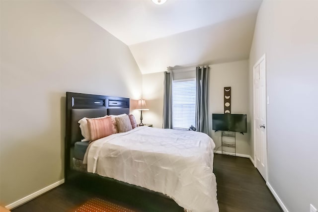 bedroom with baseboards, dark wood-style floors, and vaulted ceiling