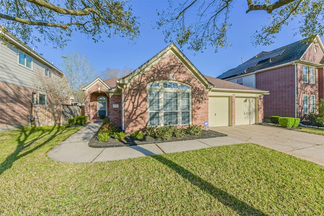 view of front of property with a front yard, fence, driveway, a garage, and brick siding