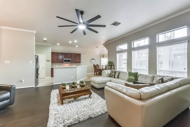 living room featuring baseboards, visible vents, recessed lighting, ceiling fan, and ornamental molding