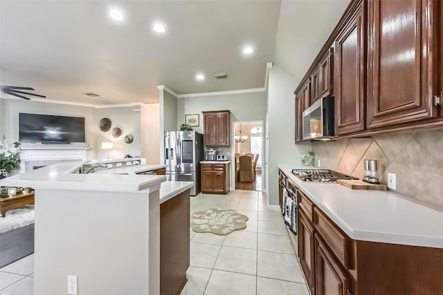 kitchen featuring a kitchen island with sink, appliances with stainless steel finishes, light countertops, light tile patterned floors, and decorative backsplash