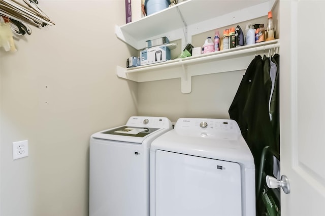 washroom featuring washer and clothes dryer and laundry area