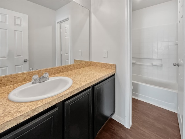 full bath featuring vanity and wood finished floors