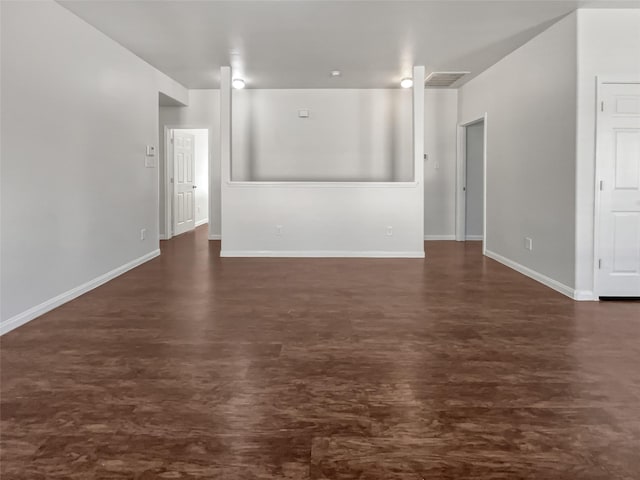 unfurnished living room with baseboards and visible vents