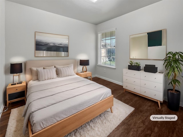 bedroom featuring baseboards and wood finished floors