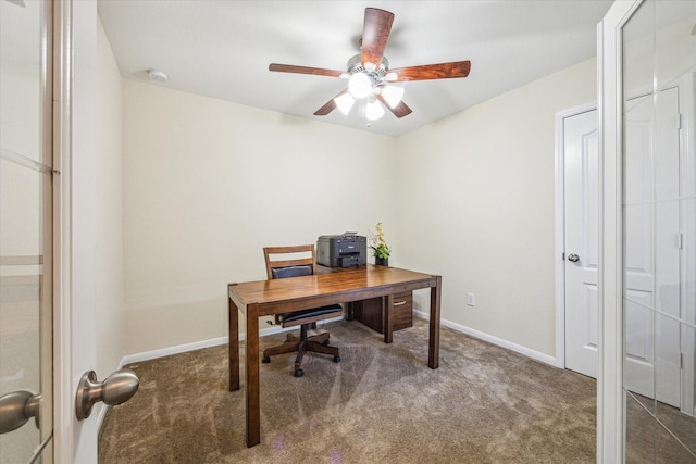 office space with carpet flooring, a ceiling fan, and baseboards