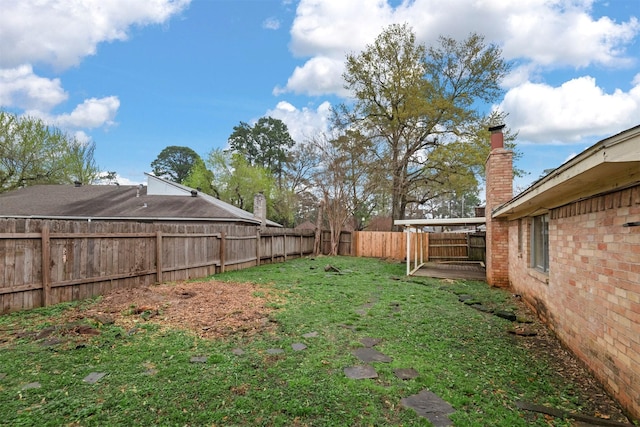 view of yard with a fenced backyard