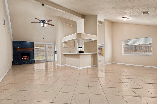 unfurnished living room featuring light tile patterned floors, visible vents, a fireplace, and a ceiling fan