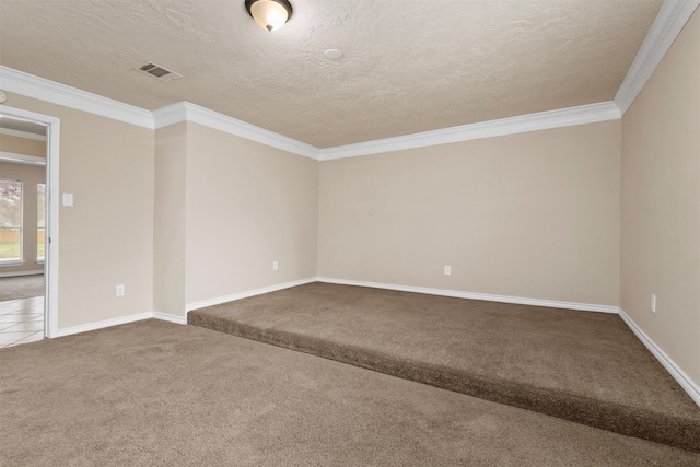 carpeted empty room with visible vents, a textured ceiling, crown molding, and tile patterned flooring