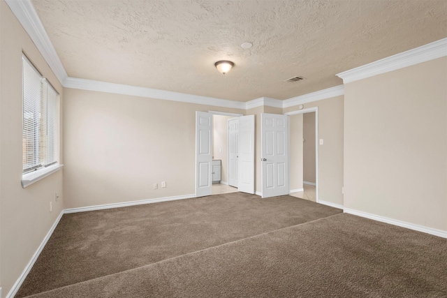 unfurnished bedroom with carpet, visible vents, baseboards, ornamental molding, and a textured ceiling