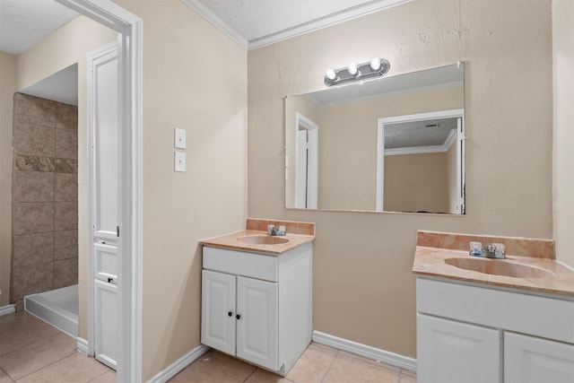 full bath featuring two vanities, ornamental molding, and a sink