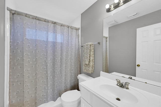 bathroom with visible vents, toilet, vanity, and a shower with curtain