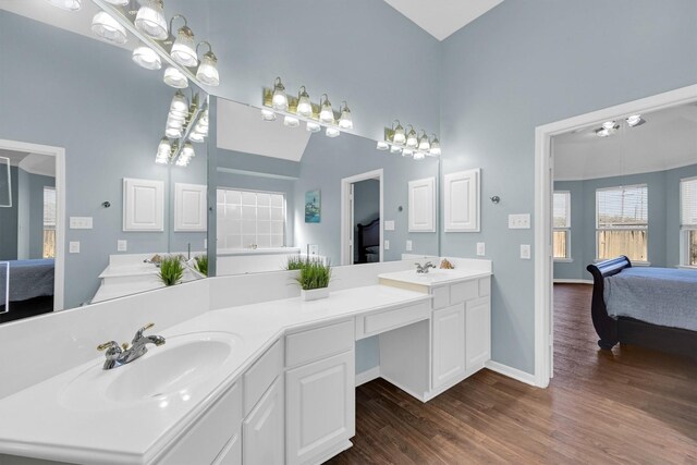 22106 Stonebriar Ln, Richmond, TX 77469 - full bathroom with high vaulted ceiling, ensuite bath, wood finished floors, and a sink