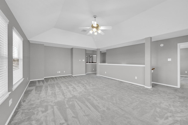 unfurnished living room featuring baseboards, lofted ceiling, carpet, and ceiling fan