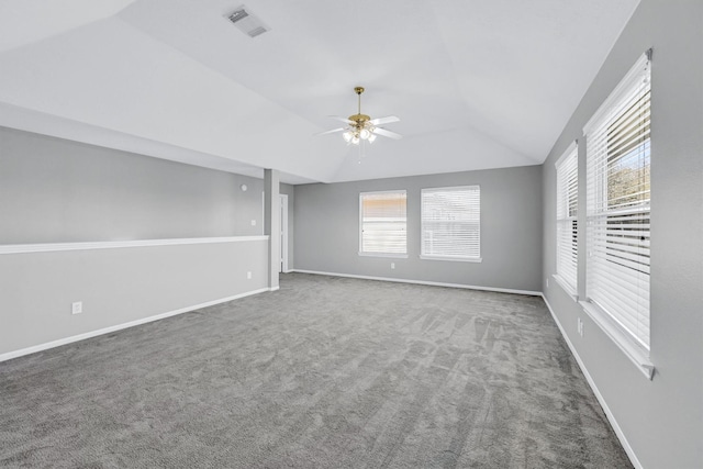 empty room featuring a ceiling fan, baseboards, visible vents, carpet floors, and lofted ceiling