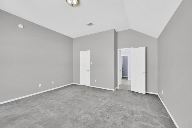 interior space featuring visible vents, carpet floors, baseboards, and vaulted ceiling