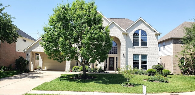 22106 Stonebriar Ln, Richmond, TX 77469 - view of front of home with brick siding, a front yard, and concrete driveway