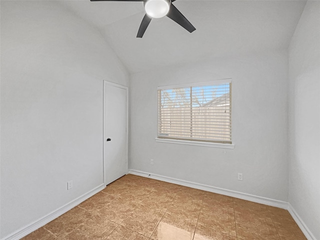 spare room featuring a ceiling fan, baseboards, and vaulted ceiling