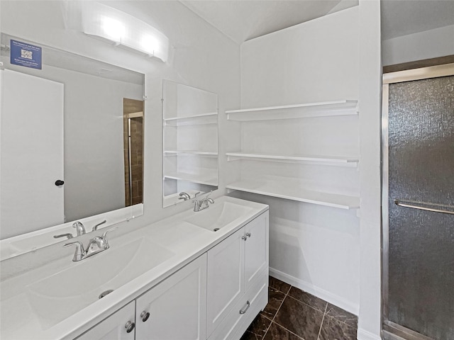 bathroom featuring a sink, double vanity, and a shower stall