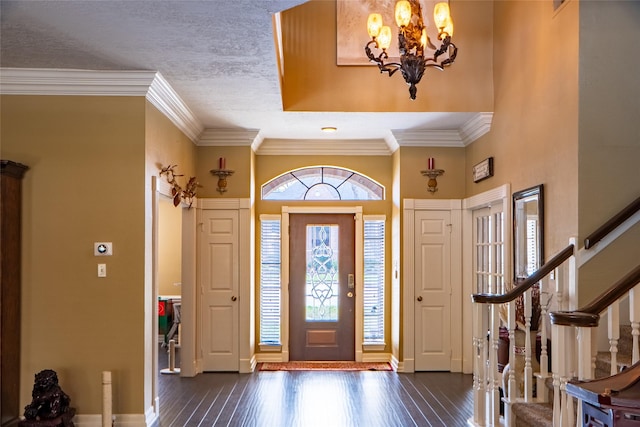 foyer featuring a wealth of natural light, stairway, and dark wood-style floors