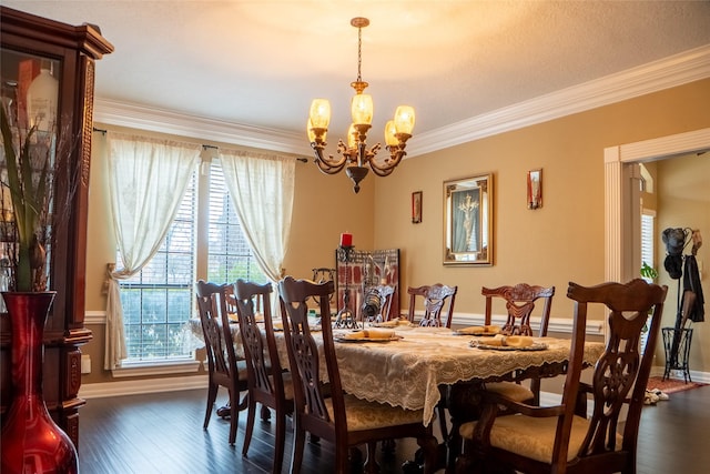 dining area featuring dark wood-type flooring, baseboards, crown molding, and an inviting chandelier