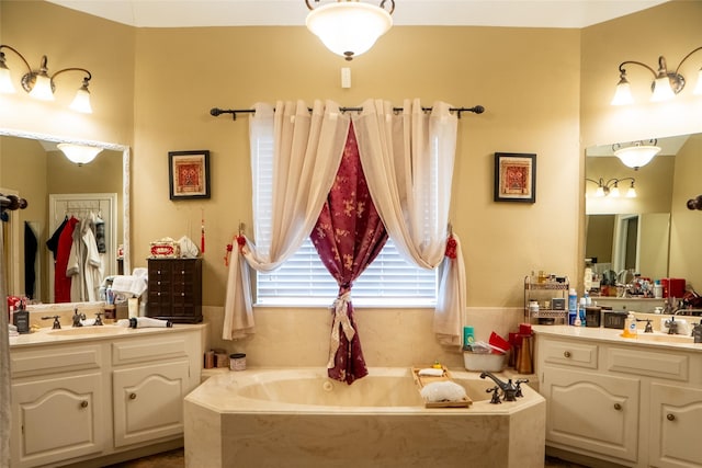 bathroom with a sink, two vanities, and a bath