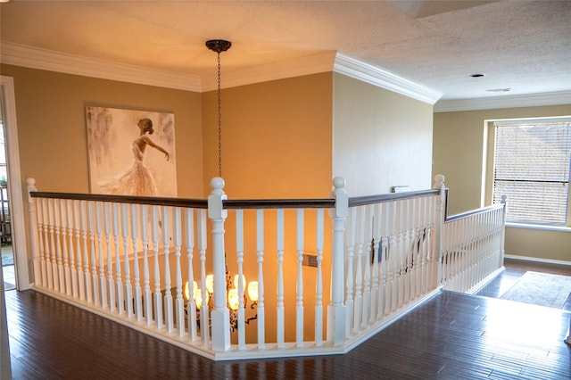 corridor featuring crown molding, an upstairs landing, wood finished floors, and baseboards