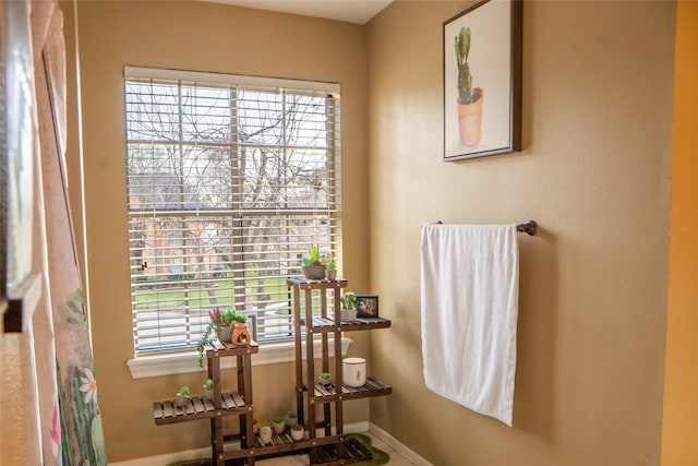 bathroom with baseboards and a healthy amount of sunlight