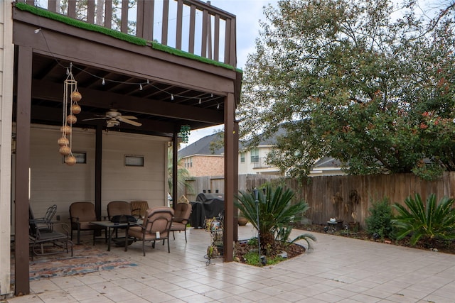 view of patio / terrace with ceiling fan and fence