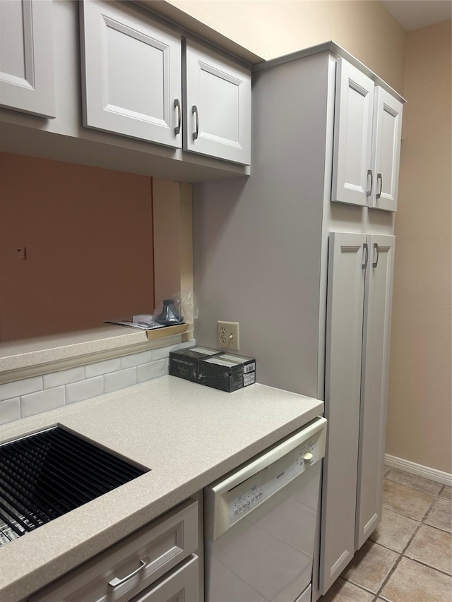 kitchen featuring white cabinetry, light tile patterned flooring, white dishwasher, and light countertops