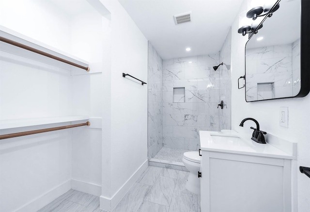 full bath with a marble finish shower, visible vents, toilet, and baseboards