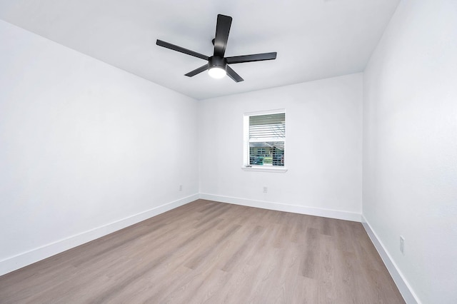 unfurnished room featuring baseboards, wood finished floors, and a ceiling fan