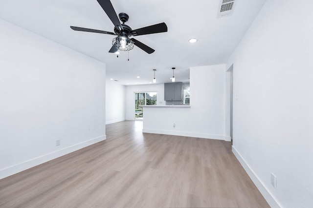 unfurnished living room featuring visible vents, baseboards, recessed lighting, ceiling fan, and light wood-style floors