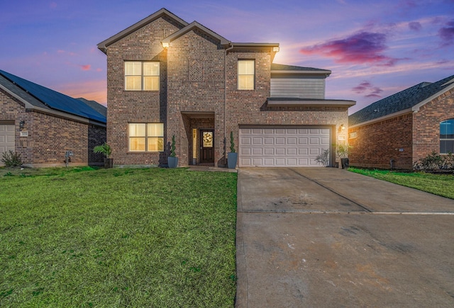 traditional-style home with brick siding, concrete driveway, and a lawn