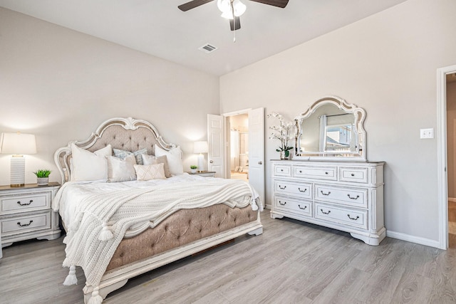 bedroom with light wood finished floors, visible vents, connected bathroom, baseboards, and ceiling fan