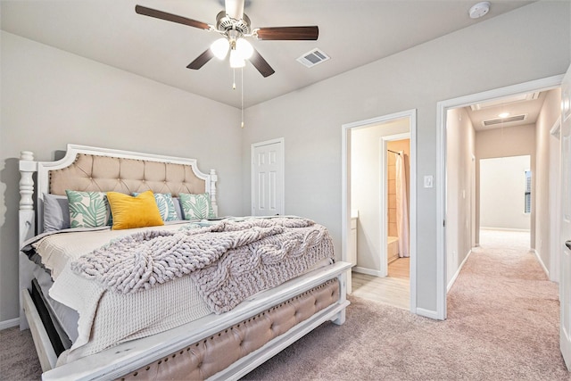 carpeted bedroom featuring visible vents, baseboards, attic access, and ceiling fan