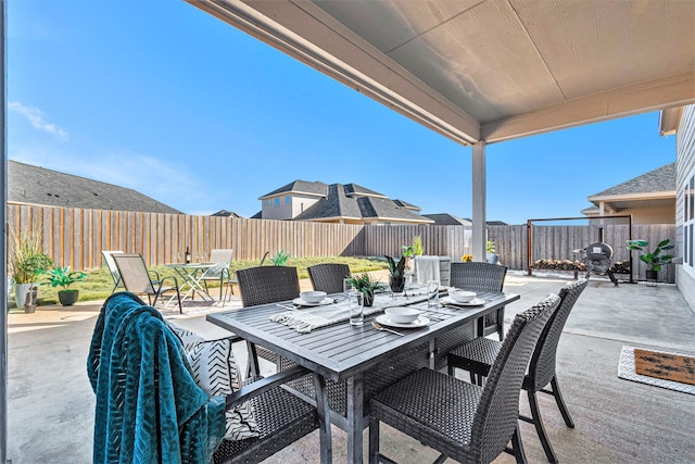 view of patio with outdoor dining area and a fenced backyard