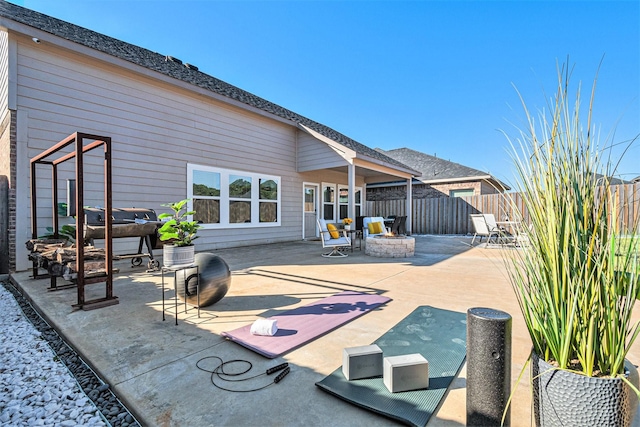 view of patio / terrace with a fire pit and fence