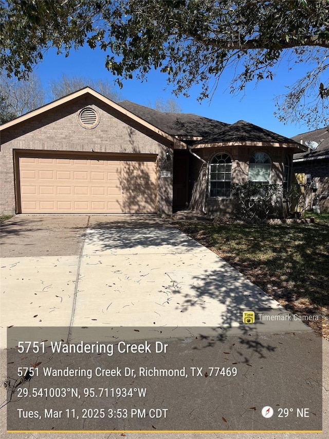 single story home featuring a garage and driveway