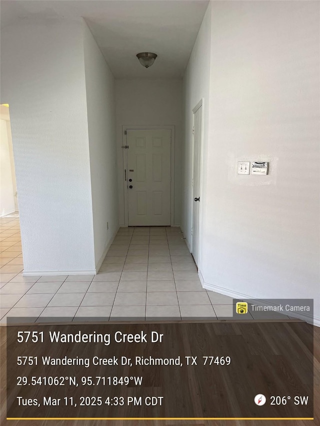 corridor featuring tile patterned flooring