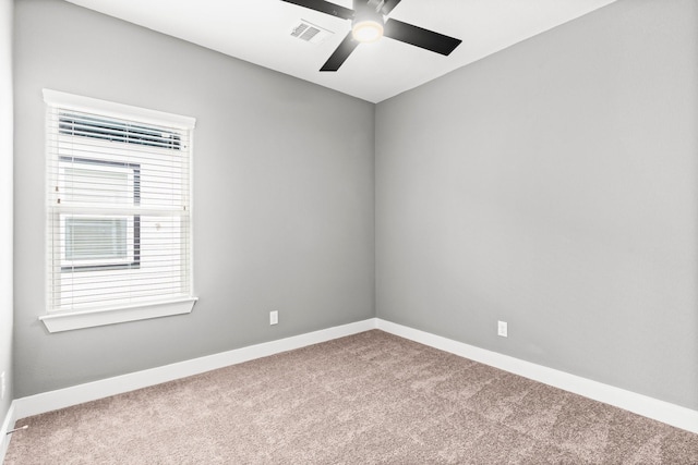 empty room featuring carpet flooring, baseboards, and visible vents