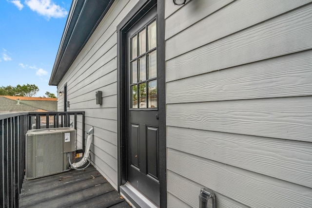 doorway to property featuring a balcony and central AC unit