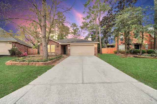 view of front of house with a front lawn, driveway, fence, a garage, and brick siding