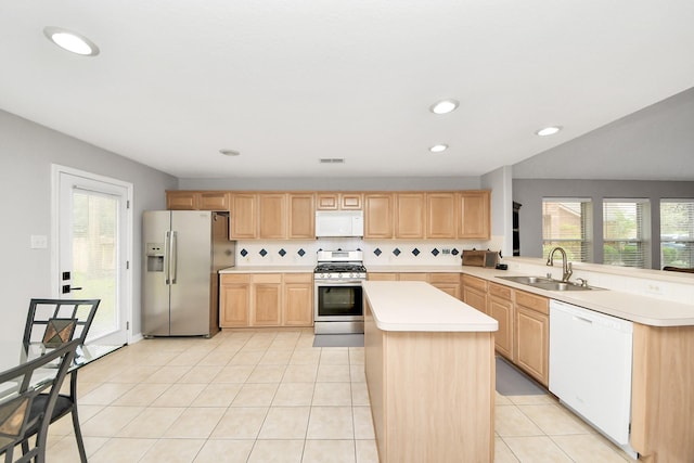 kitchen with a sink, appliances with stainless steel finishes, light tile patterned flooring, and light brown cabinets