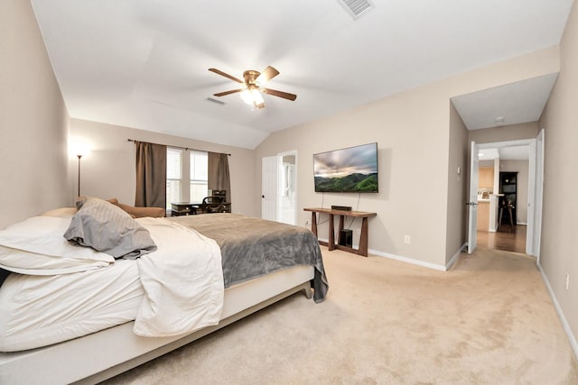 bedroom featuring light carpet, visible vents, lofted ceiling, and baseboards