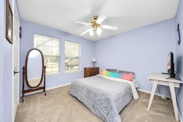 carpeted bedroom with baseboards and ceiling fan